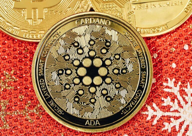 gold Cardano coin on red background 768x544.jpg