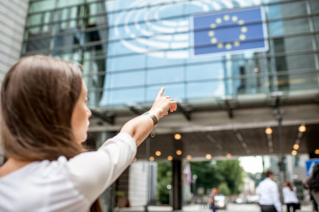 woman points to european union flag.jpg